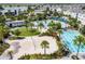 Aerial view of community amenities, including pools, volleyball court, and green spaces at 8679 Laureate Blvd, Orlando, FL 32827