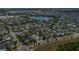 Neighborhood aerial view showcasing homes and a beautiful lake in a vibrant community at 8679 Laureate Blvd, Orlando, FL 32827