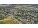 Aerial view showcases the community with a scenic lake and well-maintained streets at 8679 Laureate Blvd, Orlando, FL 32827