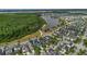 Aerial view featuring the neighborhood's location bordering wooded area and a scenic lake at 8679 Laureate Blvd, Orlando, FL 32827