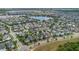 Neighborhood aerial view showcasing homes and a beautiful lake in a vibrant community at 8679 Laureate Blvd, Orlando, FL 32827
