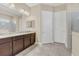 Elegant bathroom with granite countertops, dual vanities, and tile flooring, providing a luxurious and functional space at 8679 Laureate Blvd, Orlando, FL 32827