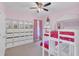 Pink bedroom with bunkbeds, storage units and natural light at 8679 Laureate Blvd, Orlando, FL 32827
