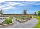 Community garden with raised beds, flourishing plants, and scenic views creates a welcoming space for residents at 8679 Laureate Blvd, Orlando, FL 32827