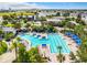 Community pool area with palm trees, lounge chairs, and cabanas, offering residents a resort-like experience at 8679 Laureate Blvd, Orlando, FL 32827
