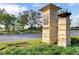 Community entrance featuring a stone monument with the 