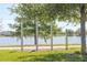 Outdoor fitness area with pull-up bars next to a scenic pond and green grass, offering a refreshing exercise environment at 8679 Laureate Blvd, Orlando, FL 32827