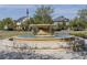 Community park fountain with tiered stone design offers a serene focal point, surrounded by lush greenery at 8679 Laureate Blvd, Orlando, FL 32827