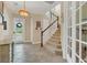 Open and bright foyer with tile flooring, staircase, and lots of natural light at 8679 Laureate Blvd, Orlando, FL 32827