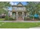 Charming two-story home with a cozy front porch, landscaped yard, and inviting curb appeal at 8679 Laureate Blvd, Orlando, FL 32827