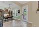 Well-lit home office near the front door with hard floors and desk at 8679 Laureate Blvd, Orlando, FL 32827
