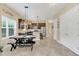 Open kitchen and dining area with stainless steel appliances and dark brown cabinets at 8679 Laureate Blvd, Orlando, FL 32827