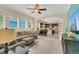 Open-concept living room flows into a modern kitchen with stainless steel appliances and a breakfast bar at 8679 Laureate Blvd, Orlando, FL 32827