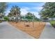 Community playground with diverse equipment and shade trees, creates an engaging space for children to play and socialize at 8679 Laureate Blvd, Orlando, FL 32827