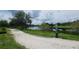 A scenic view of the pond and walking trail in the Laureate Park community, offering a tranquil and inviting outdoor space at 8679 Laureate Blvd, Orlando, FL 32827