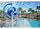 Fun splash pad feature at community pool with water wheel and blue accents at 8679 Laureate Blvd, Orlando, FL 32827
