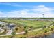 Community sports field with soccer goals, a playground, and lake views, is perfect for active recreation at 8679 Laureate Blvd, Orlando, FL 32827