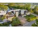 Aerial view of luxurious waterfront property with lush landscaping and multiple living spaces at 8988 Houston Pl # 303, Orlando, FL 32819
