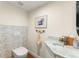 Well decorated half bath featuring a patterned tile backsplash and countertop decor at 8988 Houston Pl # 303, Orlando, FL 32819