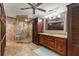 Spacious bathroom featuring a glass-enclosed shower, vanity with drawers and cabinets at 8988 Houston Pl # 303, Orlando, FL 32819