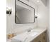 Clean bathroom featuring a mirror, modern vanity, quartz countertop and decor at 8988 Houston Pl # 303, Orlando, FL 32819