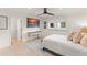 Comfortable bedroom with a TV, console table, light wood floors, and natural light at 8988 Houston Pl # 303, Orlando, FL 32819