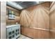 Elevator interior featuring decorative wooden paneling, lighting, and a small display cabinet at 8988 Houston Pl # 303, Orlando, FL 32819