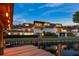 Waterfront property featuring a charming multi-story home with balconies and manicured landscaping at 8988 Houston Pl # 303, Orlando, FL 32819