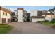 Exterior view of a modern building with a brick driveway and well-manicured landscaping at 8988 Houston Pl # 303, Orlando, FL 32819