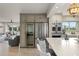 Contemporary kitchen featuring stainless steel appliances, a wine cooler, and access to the living area at 8988 Houston Pl # 303, Orlando, FL 32819