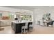 Open-concept kitchen and dining area featuring a large island and elegant dining table at 8988 Houston Pl # 303, Orlando, FL 32819