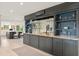 Elegant living area with a custom bar, marble countertops, and stylish shelving at 8988 Houston Pl # 303, Orlando, FL 32819