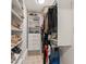 Well-organized walk-in closet with shelves, drawers, and hanging space for storage at 8988 Houston Pl # 303, Orlando, FL 32819