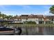 Waterfront property featuring a dock, boat, and scenic views of the water and surrounding landscape at 8988 Houston Pl # 303, Orlando, FL 32819