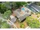 Expansive aerial view of home with a unique pool, cabana, patio and lush green surroundings at 100 Crestwood Dr, Longwood, FL 32779