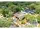 Aerial view of the house nestled among lush trees, showcasing the pool, cabana, and ample yard space at 100 Crestwood Dr, Longwood, FL 32779
