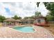 Aerial view of a landscaped backyard with an in-ground swimming pool and a deck at 100 Crestwood Dr, Longwood, FL 32779