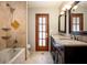Bathroom featuring a double sink vanity, tile floors, and a combined shower and tub at 100 Crestwood Dr, Longwood, FL 32779