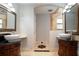 A bathroom featuring vessel sinks, custom cabinets, and ornate tile work, providing a luxurious feel at 100 Crestwood Dr, Longwood, FL 32779