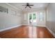 Bright bedroom with hardwood floors and backyard access through double doors for indoor/outdoor living at 100 Crestwood Dr, Longwood, FL 32779