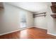 An empty bedroom with neutral walls, hardwood floors, window, and floating shelves at 100 Crestwood Dr, Longwood, FL 32779