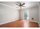 An empty bedroom featuring neutral walls, hardwood floors, and a ceiling fan at 100 Crestwood Dr, Longwood, FL 32779