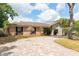 Lovely single-story home with brick and siding, plus a brick driveway and lots of trees at 100 Crestwood Dr, Longwood, FL 32779