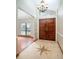 Foyer with starburst-patterned tile floor and wood double doors at 100 Crestwood Dr, Longwood, FL 32779