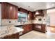 Well-appointed kitchen featuring granite countertops, tile backsplash, and wood cabinetry at 100 Crestwood Dr, Longwood, FL 32779