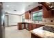 Modern kitchen with stainless steel appliances, granite countertops, and cherry wood cabinets at 100 Crestwood Dr, Longwood, FL 32779