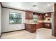 Charming kitchen features dark wood cabinetry, tile flooring, granite countertops, and stainless steel appliances at 100 Crestwood Dr, Longwood, FL 32779