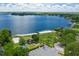 Scenic aerial view of a beautiful lake with a beach, playground, and lush greenery at 100 Crestwood Dr, Longwood, FL 32779