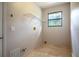 Laundry room features tile floors, a window, and plenty of space for storage and appliances at 100 Crestwood Dr, Longwood, FL 32779