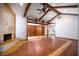 Spacious living room with beamed ceilings, hardwood floors, fireplace, and natural light throughout at 100 Crestwood Dr, Longwood, FL 32779